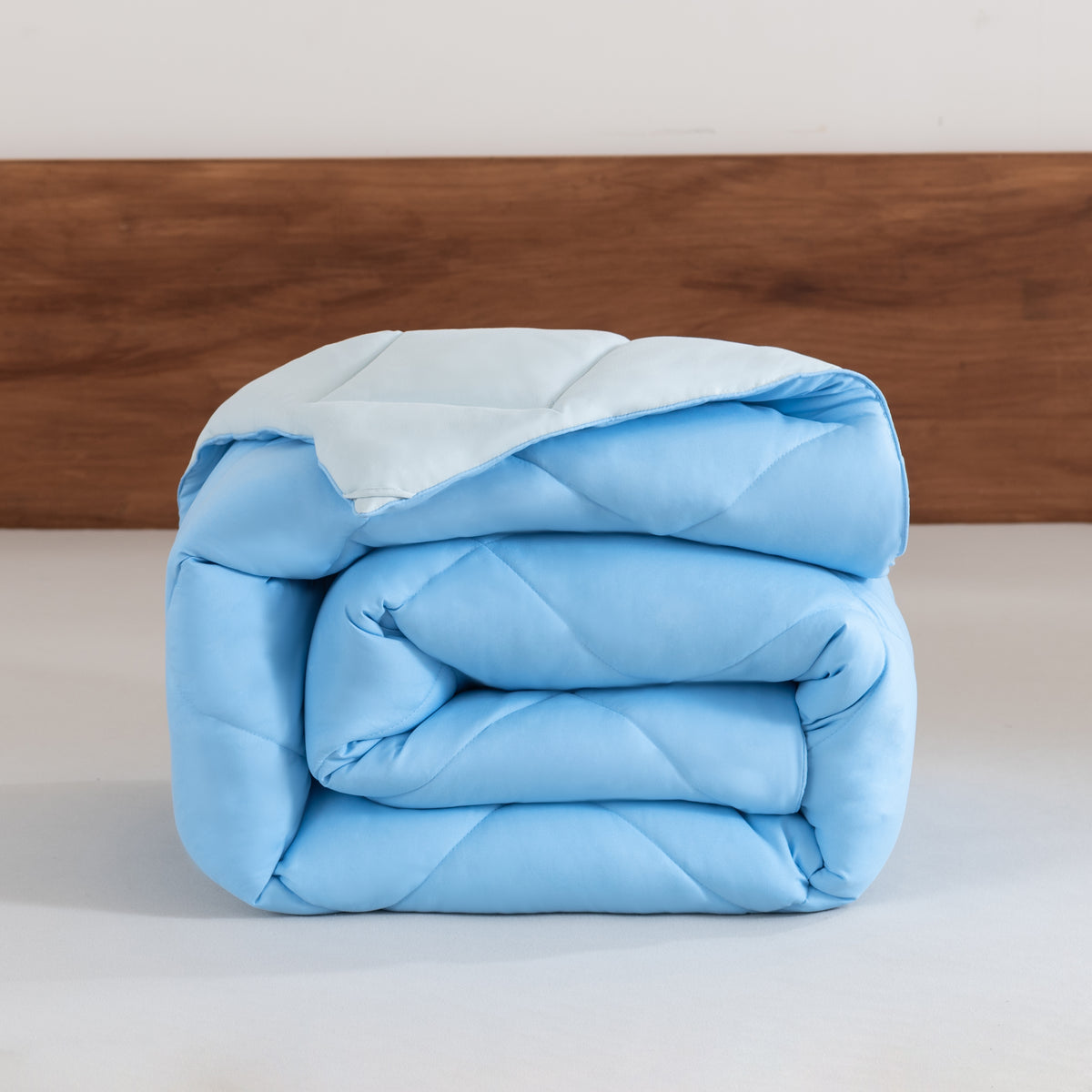 Snoozella ComfyBed Duo Lichtblauw op een opgemaakt bed – sfeerfoto 1